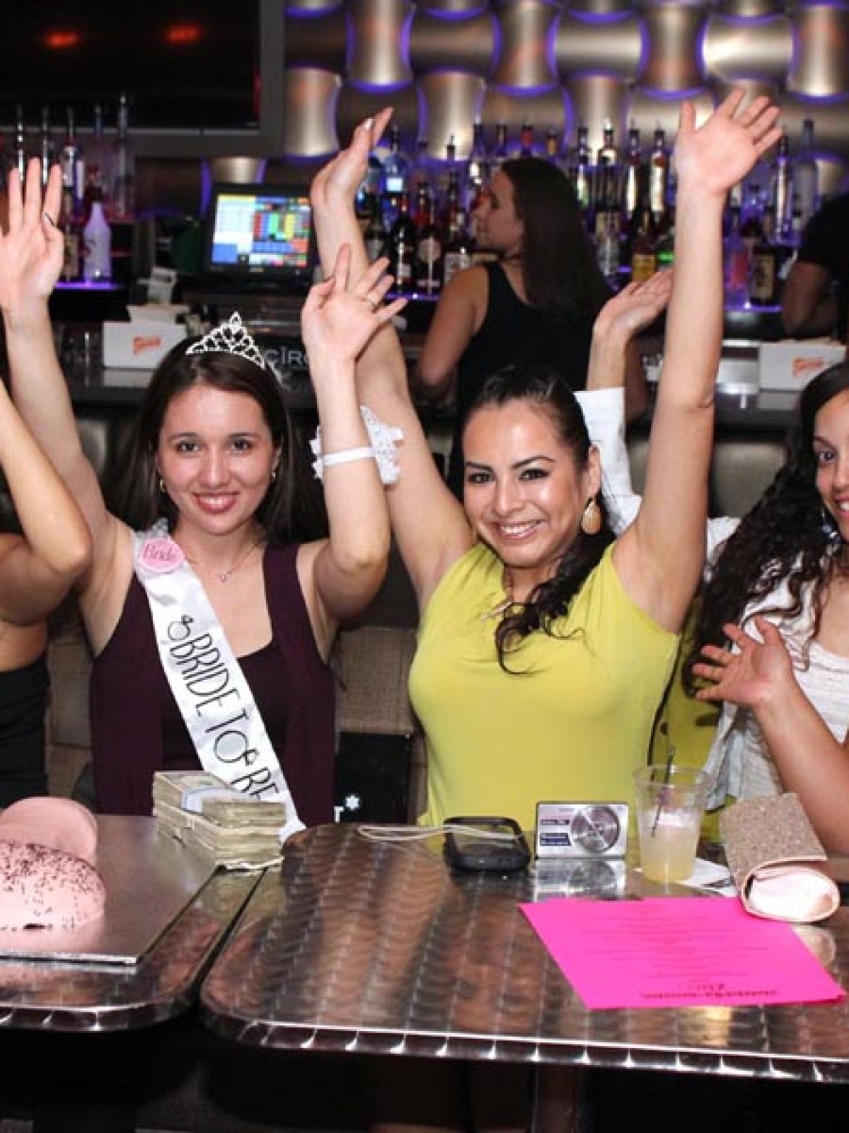 a group of people sitting at a table posing for the camera